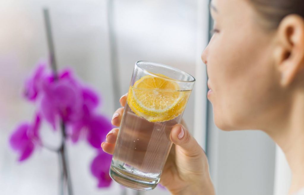 woman drinks Lemon And Ginger Water