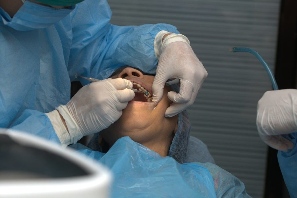 A man getting his teeth checked by a dentist
