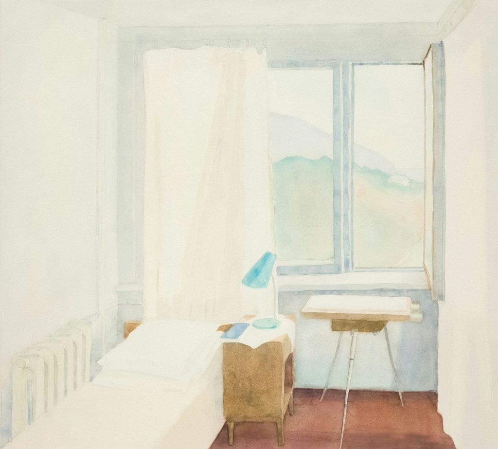 A simple room with a bed, desk, and window view.