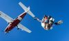 white and red airplane in mid air during daytime. is there a weight limit for skydiving
