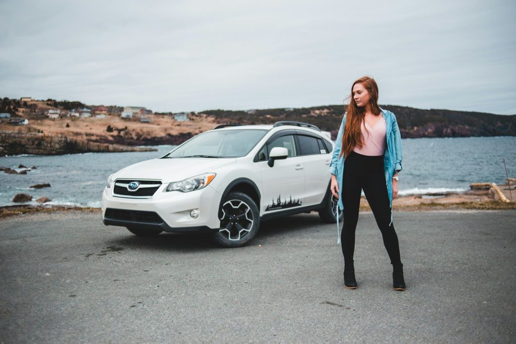 woman standing near white SUV