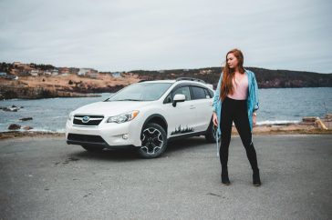 woman standing near white SUV
