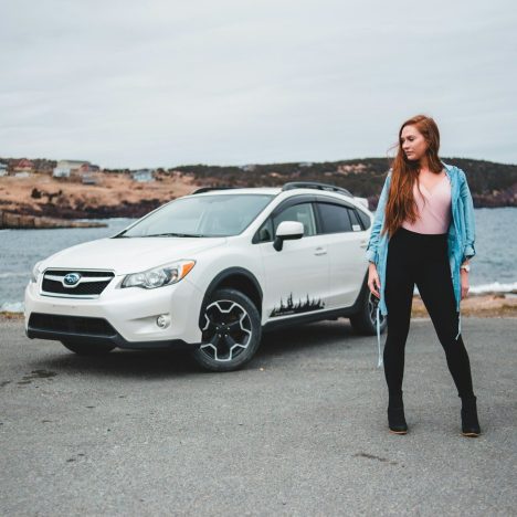 woman standing near white SUV
