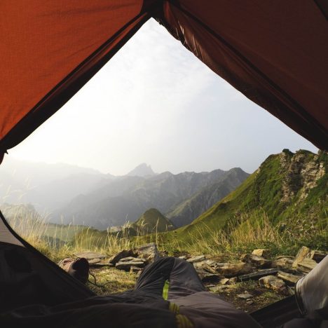 a view from inside a tent of a mountain range