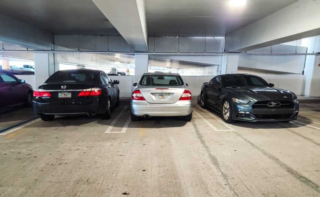 A group of cars parked in a parking garage