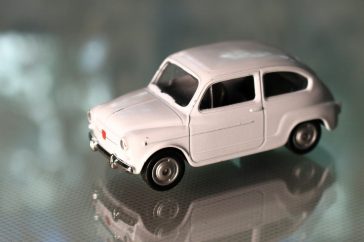 a white toy car sitting on top of a table