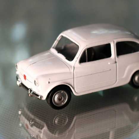a white toy car sitting on top of a table