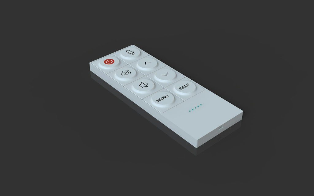 A white remote control lies on a reflective surface.