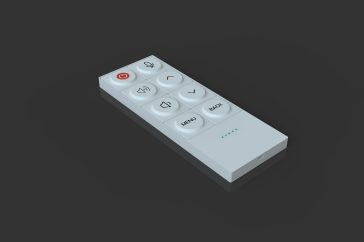 A white remote control lies on a reflective surface.