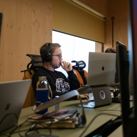 a man sitting at a desk with headphones on