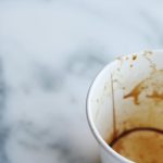 An artistic close-up of an empty coffee cup on a marble surface, capturing a minimalist aesthetic.