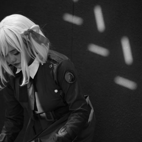 Woman in costume with blonde wig and bow