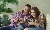 Couple playing video games on couch