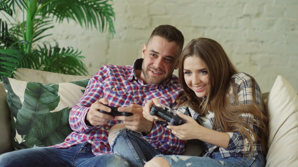 Couple playing video games on couch