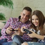 Couple playing video games on couch