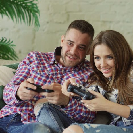 Couple playing video games on couch