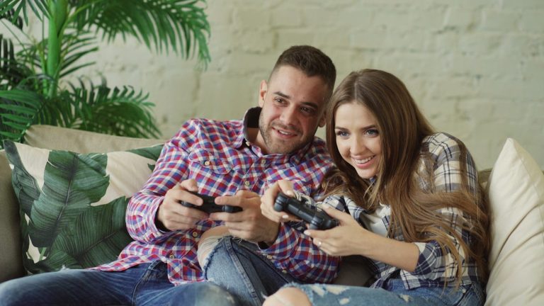 Couple playing video games on couch