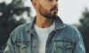 a man with a beard wearing a denim jacket