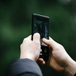 a person taking a picture with a cell phone