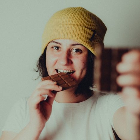 woman in white crew neck t-shirt wearing yellow knit cap