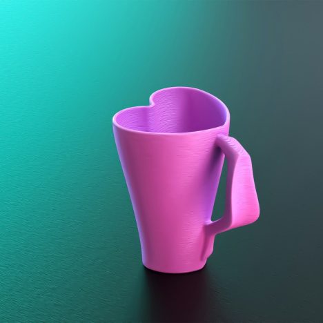 A pink coffee cup sitting on top of a table