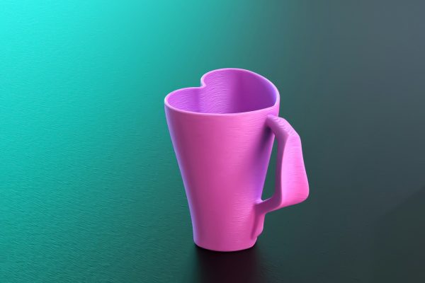 A pink coffee cup sitting on top of a table