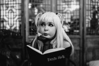 a woman with long blonde hair is reading a book