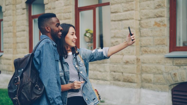 A couple takes a selfie outdoors.