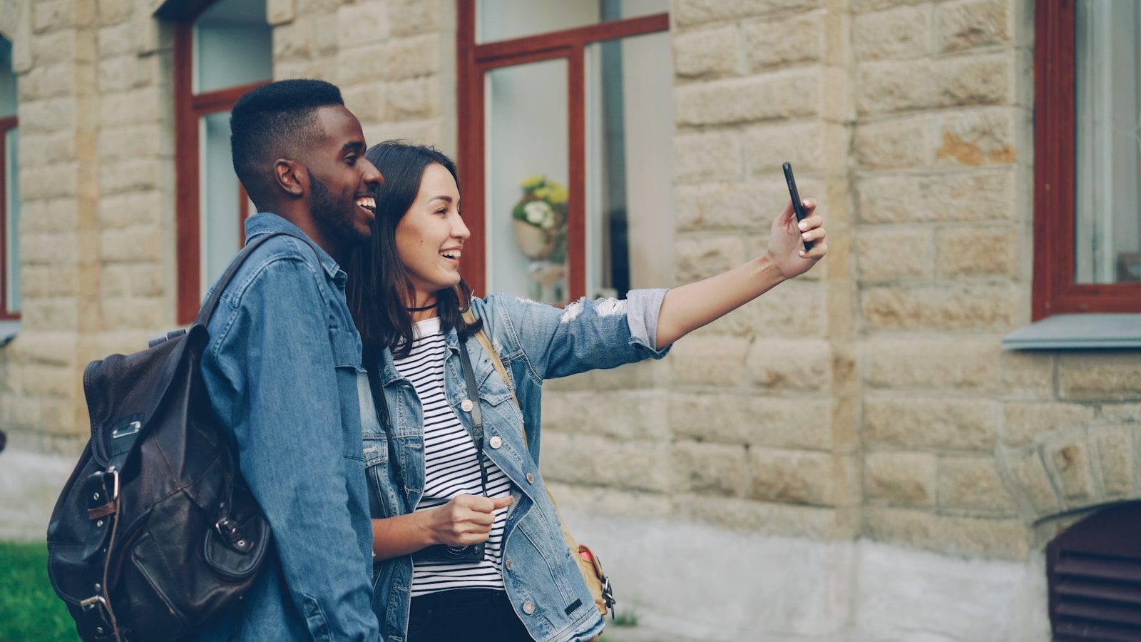 A couple takes a selfie outdoors.