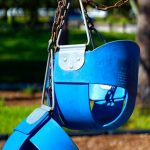 blue swing chair on green grass field during daytime