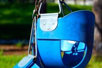 blue swing chair on green grass field during daytime