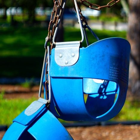 blue swing chair on green grass field during daytime