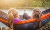 two women lying on hammock